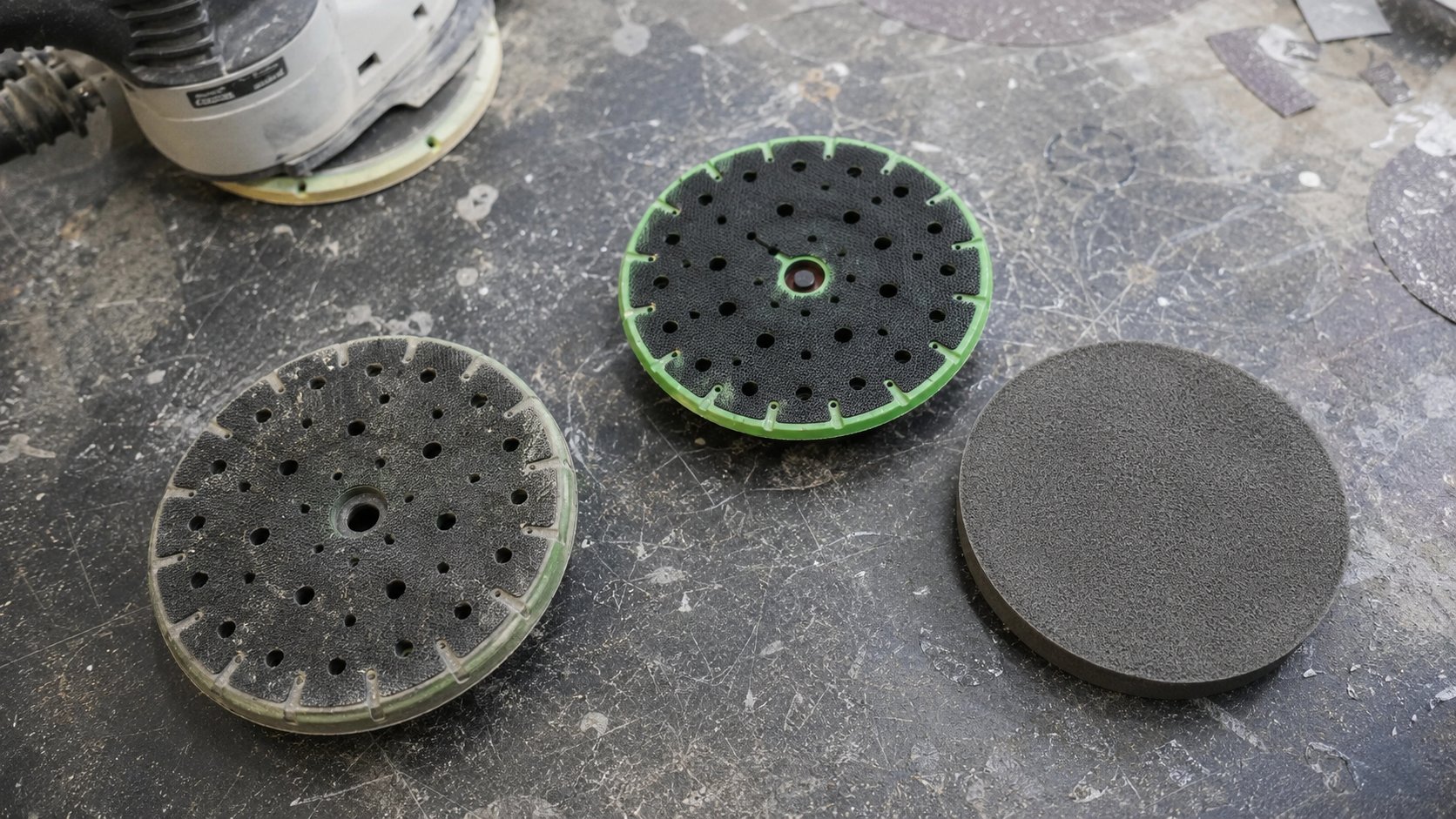 Worn DA backing pad compared with a fresh pad and interface pad.
